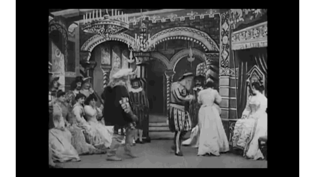 A scene from Blue Beard with a static camera showing people coming in and out of the scene