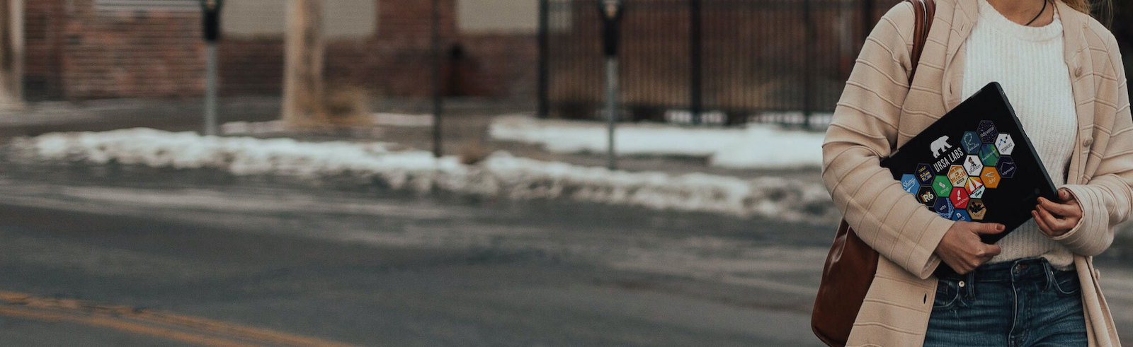 Student with laptop covered in R stickers