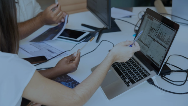 An open laptop on a desk with an analytics dashboard open on the screen