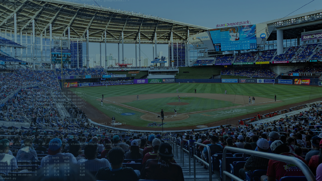 A photo of a baseball stadium taken from seats behind the home base