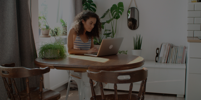 woman on laptop at kitchen table