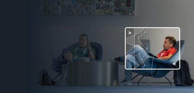 Blue-tinted background of people seated with a bright inset of a man working on a laptop.