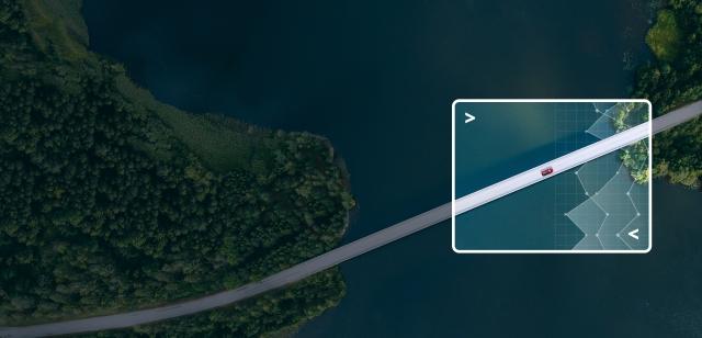 Aerial view of a car driving across a bridge with a focus on data visualizations around the car.
