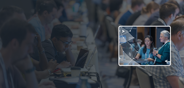 Blue-tinted background of a large technical workshop with a bright inset photo of two women collaborating on a laptop.