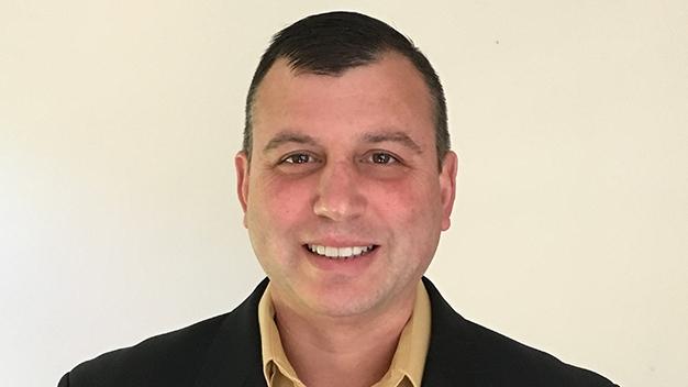 portrait of Bryan Butler in front of cream colored wall