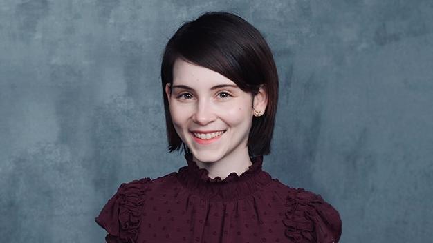 portrait of Rebecca Hadi in front of dark gray textured background