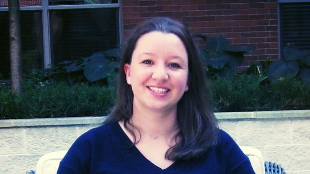 portrait of Tanya Cashorali smiling and sitting in lounge chair outside