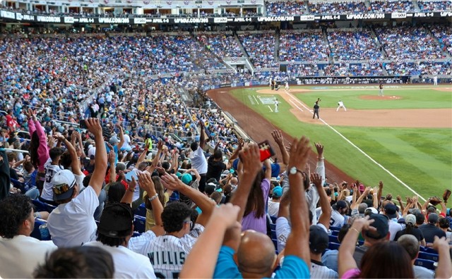 A crowd cheering at a baseball game