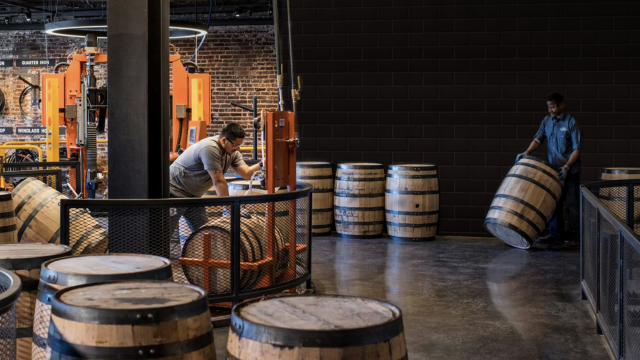A barrel room with text that says "Brown-Forman handcrafts our own barrels"