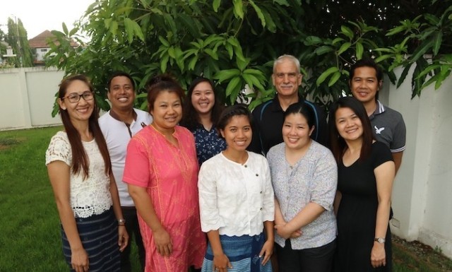 9 people from the FCF standing outside smiling and posing for the camera.