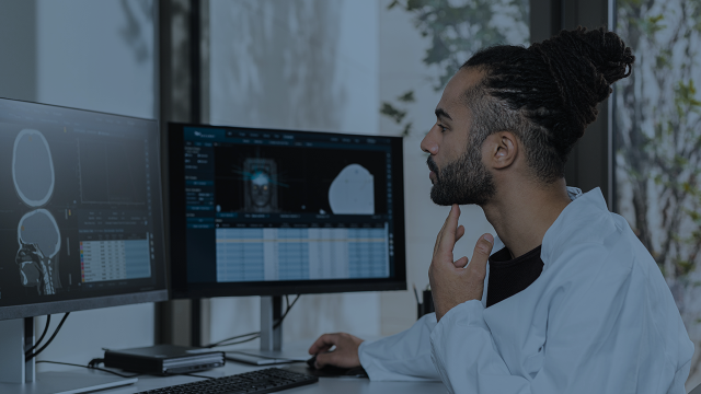 A man doing analytics work on a monitor
