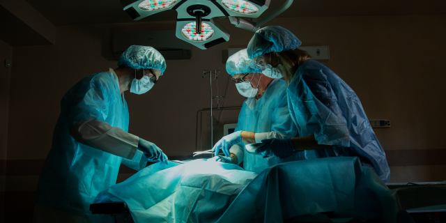 surgeons at an operating table.