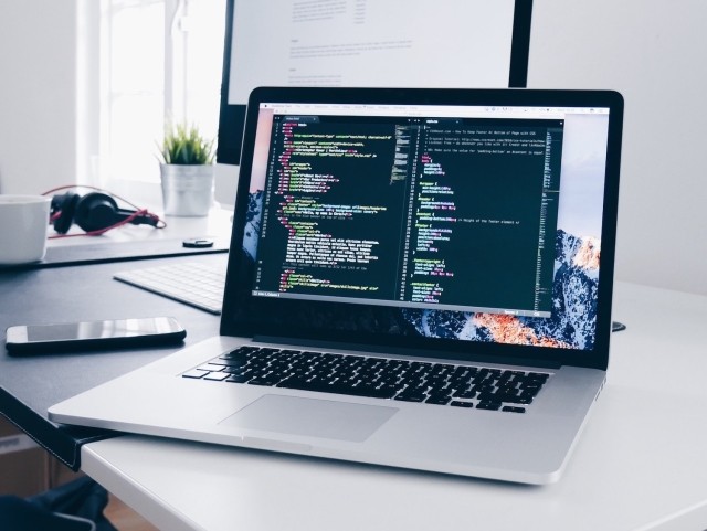 Laptop with a code editor open on the screen.