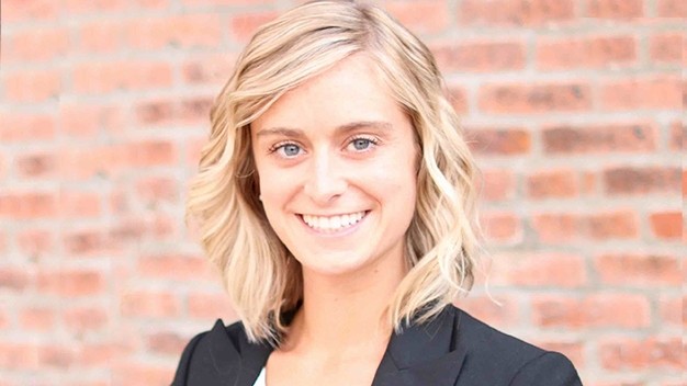 portrait of Katie Schafer in front of brick wall