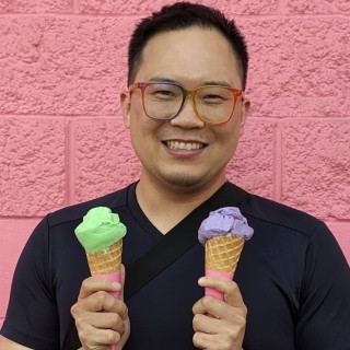 Daniel Chen holdiing green and purple ice cream cones