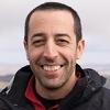 portrait of Rami Krispin outside with blurry landscape in the background