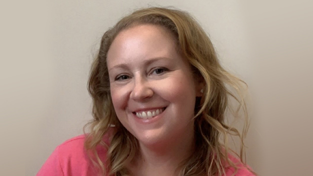 portrait of Erin Pierson in front of cream colored wall