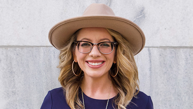 portrait of Lindsey Clark in front of large marble wall