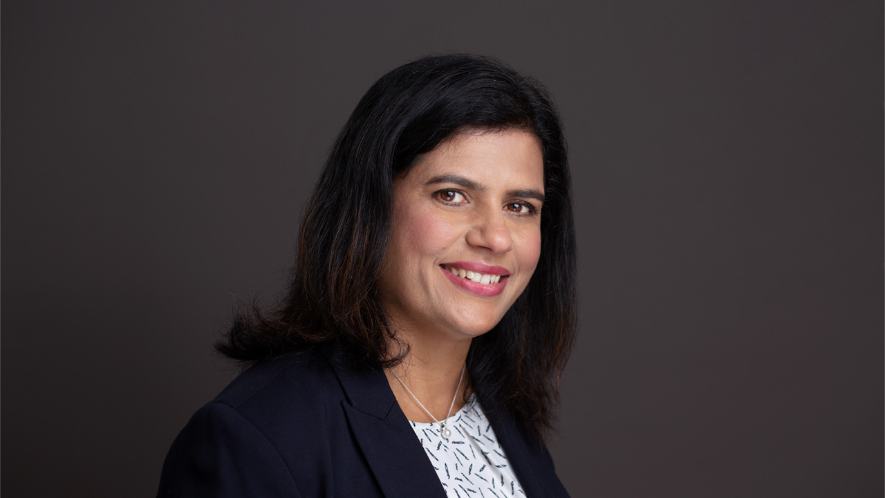 portrait of Mythili Krishnaraj on dark background