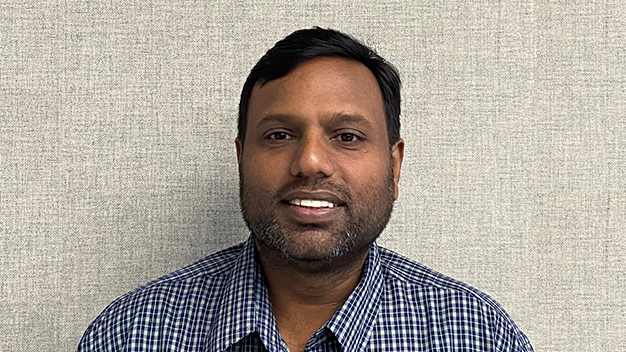 portrait of Prabha Thanikasalam in front of fabric textured wall