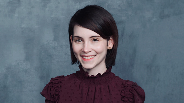 portrait of Rebecca Hadi in front of dark gray textured background