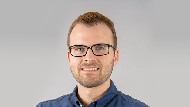 portrait of Stephan Bailey in front of light gray background