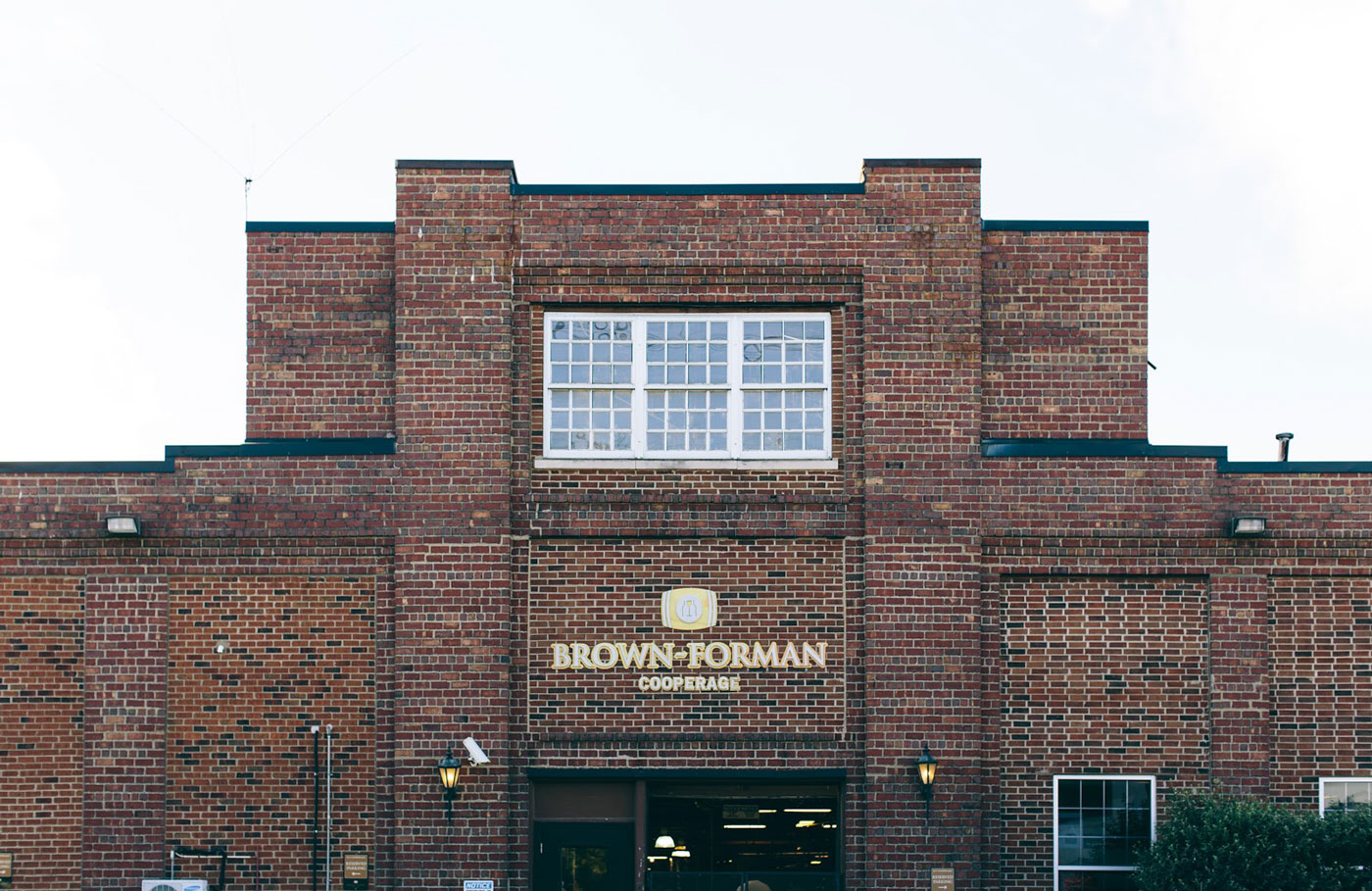 photo of brick building with Brown-Forman Cooperage logo sign