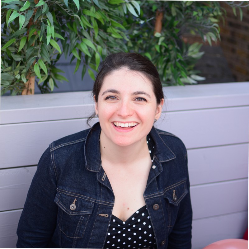 portrait of Christina Fillmore outside in front of planter and greenery