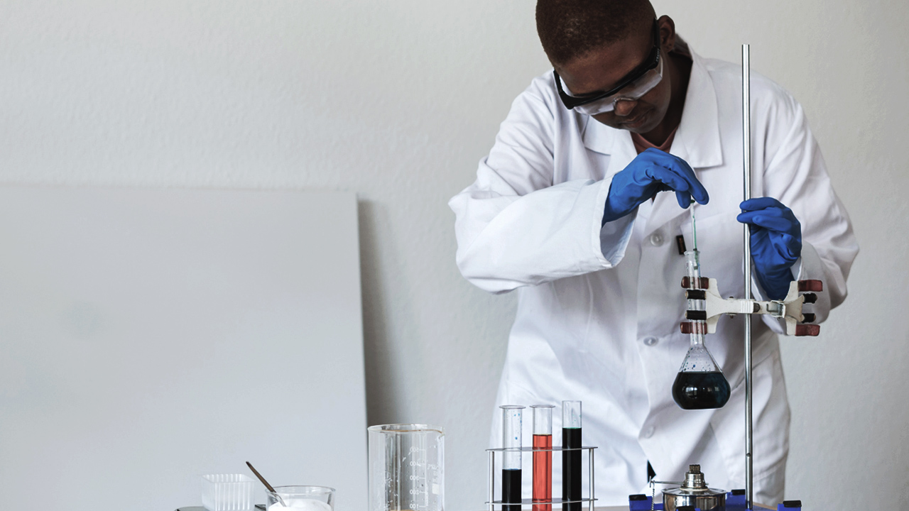 young science student extracts liquid from a beaker