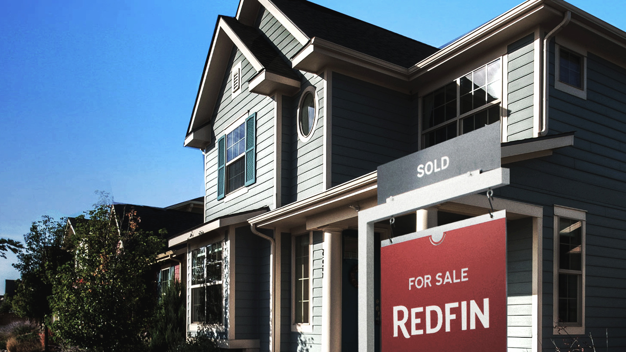 a house with close up of Redfin sold sign
