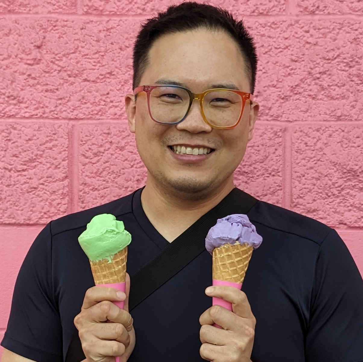 Daniel Chen holdiing green and purple ice cream cones