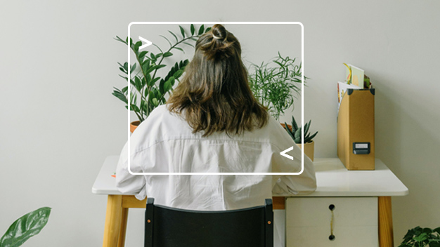 back view of woman sitting at a desk with plants on it and on the floor, woman is framed with computer terminal graphic
