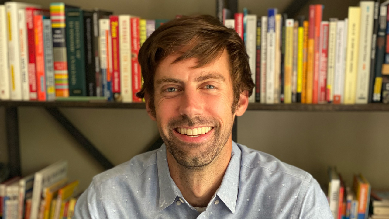 portrait of frank corrigan in front of book shelves