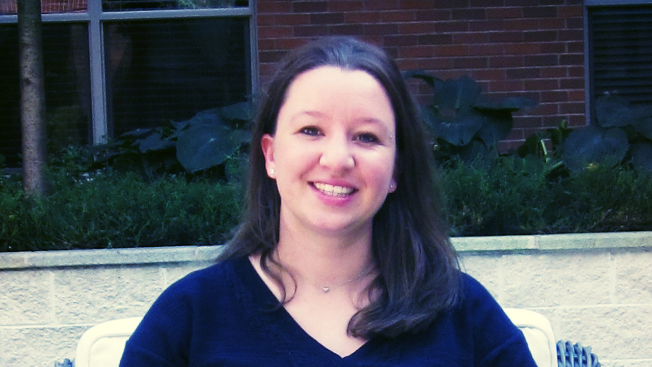 portrait of Tanya Cashorali smiling and sitting in lounge chair outside