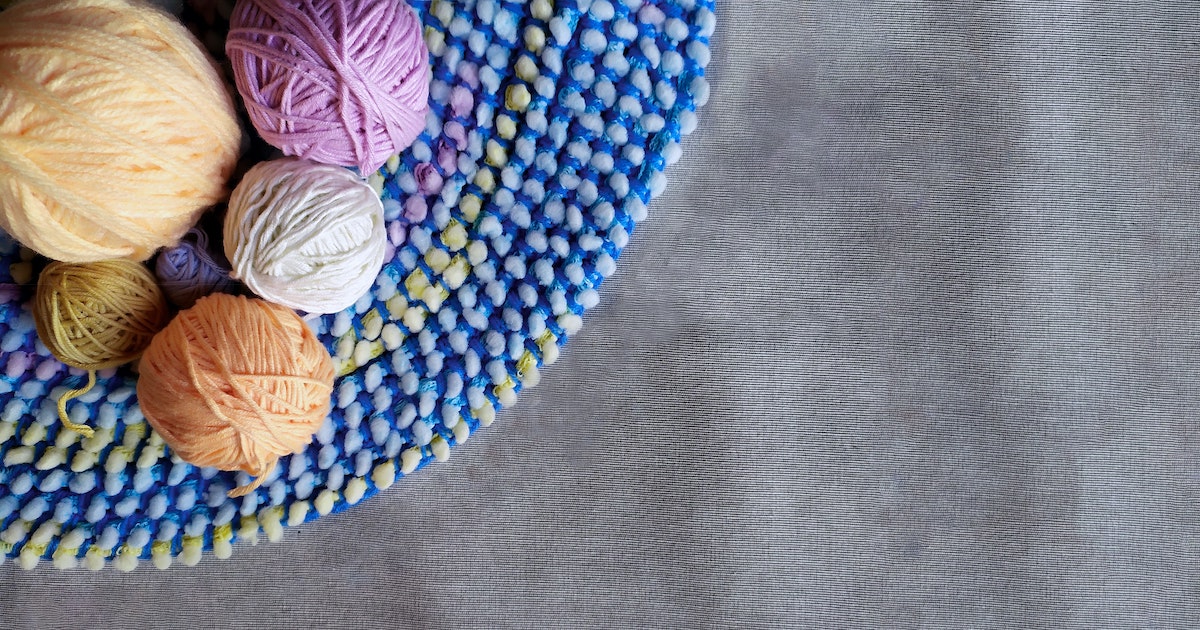 Balls of yarn on top of a colorful placemap