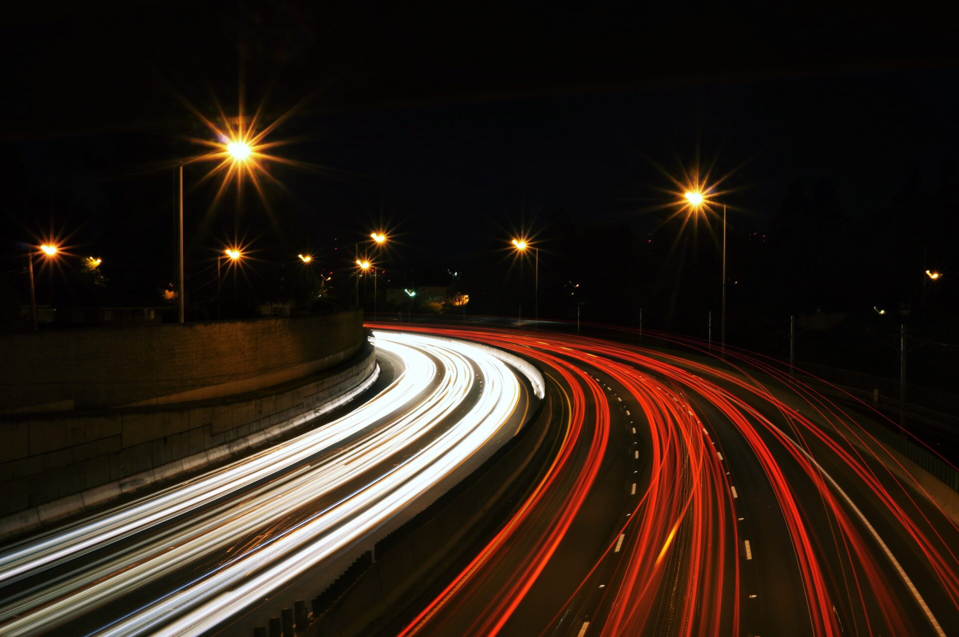 Time lapse photo of a highway road at night