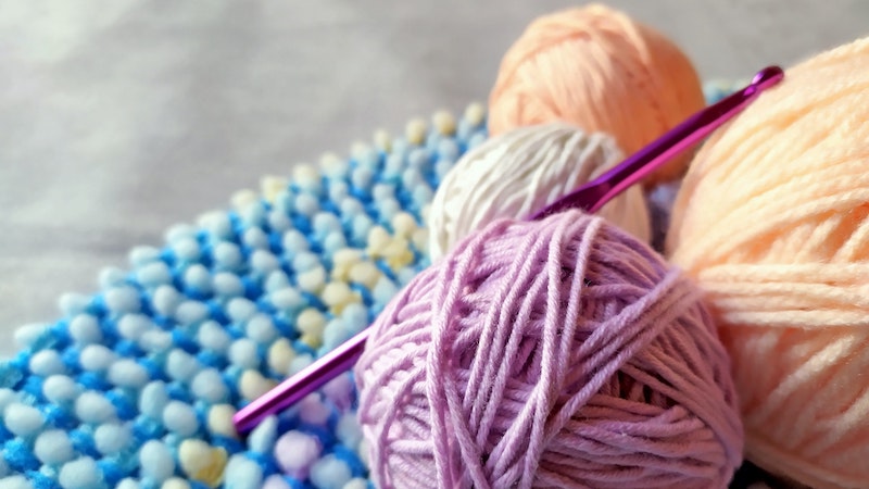 Balls of yarn and a knitting needle