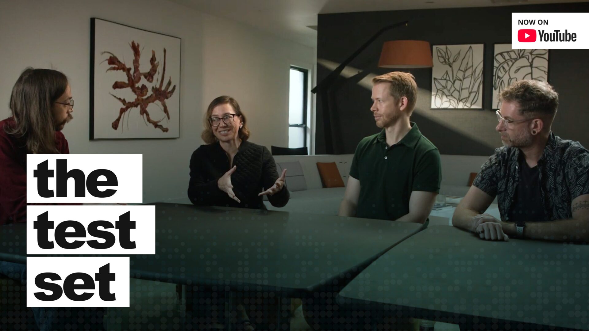 Four people sitting around a table with a title overlay, "the test set."